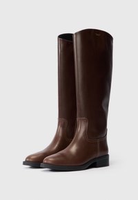 Botas de cuero marrón hasta la rodilla con un acabado suave, punta redondeada, costuras blancas en contraste y un tacón bajo de bloque.