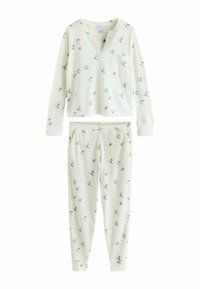 Hellcremfarbener Pyjama-Set aus weichem Stoff. Langärmliges Oberteil mit V-Ausschnitt und Brusttasche, kombiniert mit passenden Jogginghosen mit verspieltem Muster.