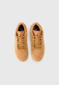 Suede tan spordijalatsid koos perforeeritud detailidega, sobivate paeltega ning punase Jumpman logo mustal sisetallal. Kummist välistald tagab haarde.