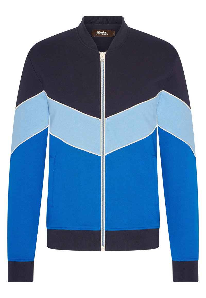 Blå bomberjacka med marinblå, ljusblå och himmelsblå färgblockering. Har dragkedjestängning, ribbade manschetter och sidofickor.
