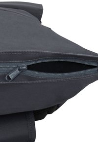 Gray fabric backpack with a smooth texture, featuring a zippered closure, sturdy seams, and an adjustable strap on the back.