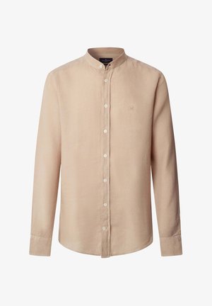 Camisa beige de manga larga con botones y cuello mandarín, con pequeño logo bordado en el pecho izquierdo.