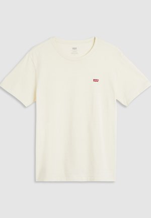 Kremna bombažna majica s kratkimi rokavi in okroglim ovratnikom, s majhnim rdečim logotipom Levi's na levi strani prsnega koša. Gladka textura, standardna prileganje.