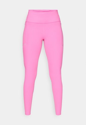 Růžové legíny vyrobené z elastického materiálu, s vysokým pasem a bočními kapsami, s hladkým povrchem a minimálními švy.