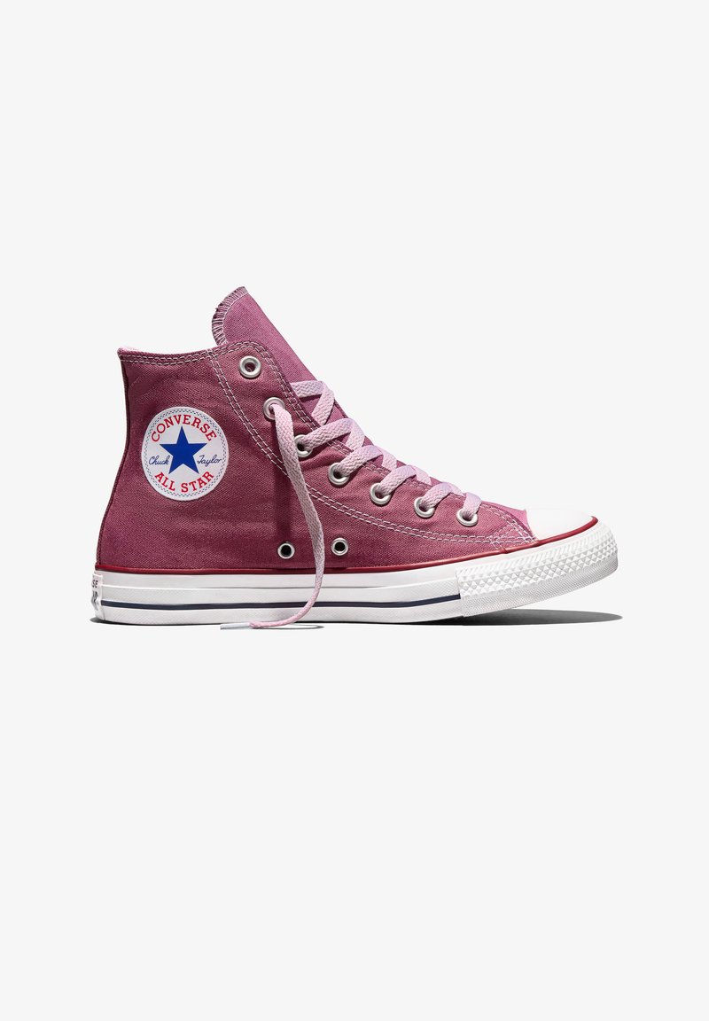 Zapatilla Converse All Star de caña alta en color malva con cordones blancos, suela de goma blanca y parche con logo de estrella azul en el tobillo.