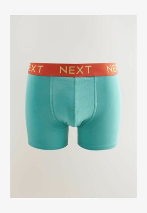 Boxeri aqua blue din bumbac moale, cu o talie roșie pe care scrie "NEXT" în litere aurii. Design ajustat cu o textură netedă.