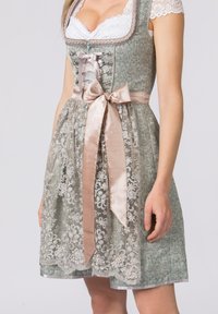 Dirndl dress in muted teal with intricate silver embroidery, a satin beige ribbon belt, and lace accents at the neckline and sleeve edges.