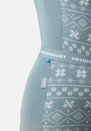 Light blue thermal garment with white snowflake and diamond patterns, featuring a soft texture and a band labeled "SWEDMOUNT" with a Swedish flag.