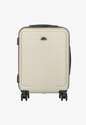 Beżowa walizka z twardą obudową z pionowymi żebrami, czarną plakietką z logo, cztery czarne obrotowe kółka oraz uchwyty po bokach i na górze.