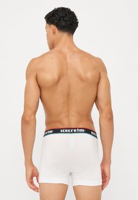 White cotton boxer briefs with a black and red waistband featuring the "icecream" logo, showing a smooth texture and fitted design.