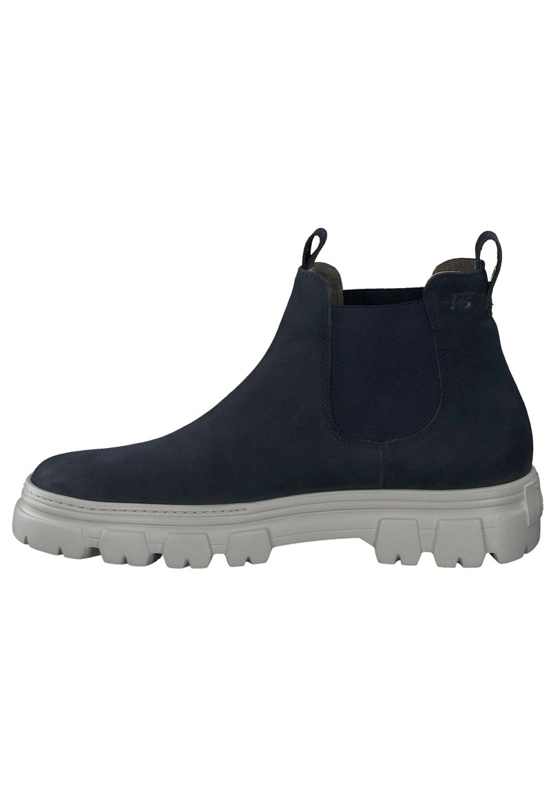 Laivastonsiniset mokkanahkaiset Chelsea-saappaat joustavilla sivupaneeleilla, vetolenkeillä ja paksuilla valkoisilla kumipohjilla, joissa on selkeät urat pitävyyttä varten.