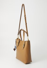 Brown leather handbag with gold hardware. Features a structured shape, short handles, and a shoulder strap. Includes decorative tassels.