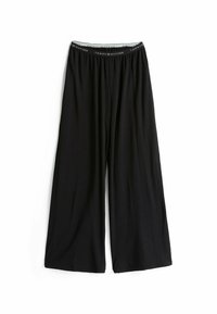 Zwarte wijde broek van zacht materiaal, met een elastische tailleband waarop de merknaam "Tommy Hilfiger" in het wit is gedrukt.