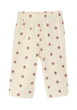 Cream-colored children's pants with elastic waistband, pink floral pattern, textured fabric, and scalloped hems.