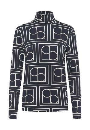 Long-sleeve turtleneck top in navy with a geometric white pattern featuring overlapping circles within squares. Soft fabric, fitted design.