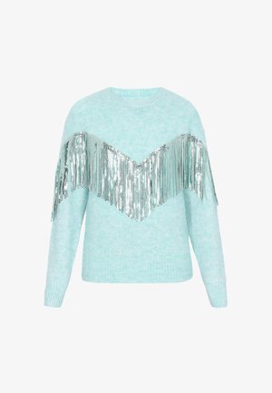 Maglione azzurro chiaro, peloso, con frange di paillettes argento disposte a V sul petto. Maniche lunghe e scollatura tonda.