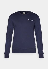 Sweat-shirt Champion bleu marine à manches longues avec petit logo sur la poitrine gauche et patch logo sur la manchette gauche.