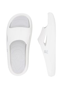 White slip-on sandals with a textured gray insole, open design, and cutouts on the sides. A subtle logo is visible on the outer side.