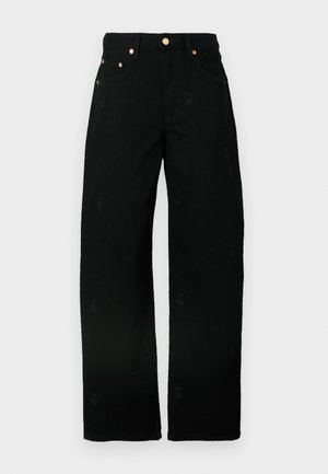 Sorte vidde jeans lavet af bomuld med en blød tekstur, der har subtile broderede mønstre og hardware i guldtoner på lommerne.