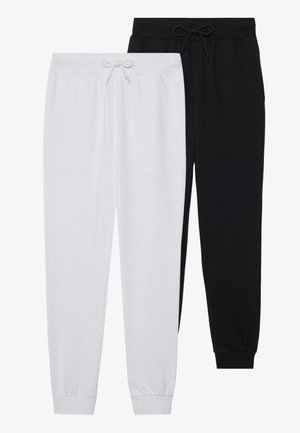 To par joggebukser: en i hvit og en i svart. Laget av mykt stoff, med elastiske mansjetter og snøring i midjen.