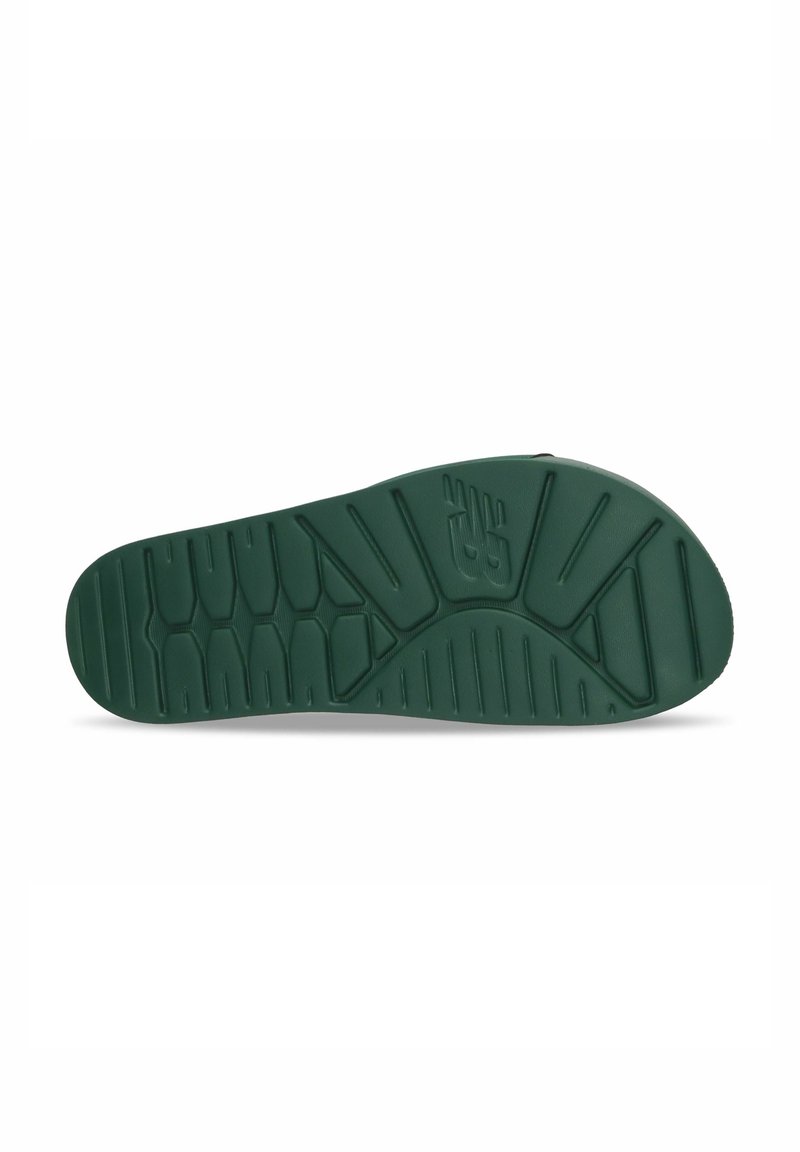 Green rubber shoe sole with textured surface, featuring grooves and ridges for grip and traction, tapered shape towards the toe.