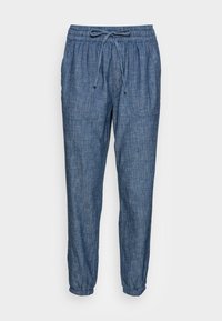 Joggers en denim bleu avec une taille élastique, un cordon de serrage réglable et des poches latérales. Coupe fuselée avec des poignets élastiqués aux chevilles.