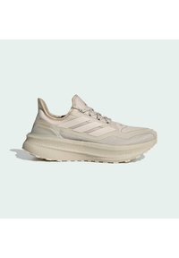 Beige athletic shoe with a textured mesh upper, padded collar, lace-up front, and a thick, cushioned sole for support and comfort.