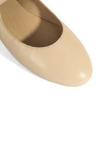 Beige Lederflachschuh mit runder Zehenpartie und glatter Oberfläche, mit einem Ausschnittdesign entlang der oberen Kante. Eleganter und minimalistische Stil.