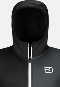 Black and gray zip-up hoodie with a high collar, a front zipper, and a white logo on the chest. Smooth fabric with a fitted design.