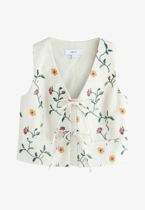 Gilet bianco senza maniche con ricami floreali multicolori, scollo a V, chiusura con laccio frontale e due tasche anteriori.