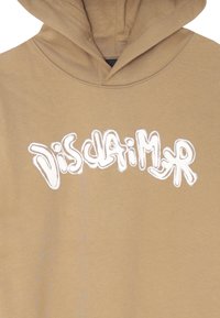 Felpa color marrone chiaro con cappuccio, che presenta la scritta in stile graffiti bianco "Disclaimer" sul petto.