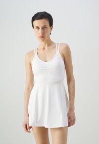 White athletic dress with a fitted bodice and flared skirt. Features thin straps and subtle gathering at the front. Smooth texture, minimal design.