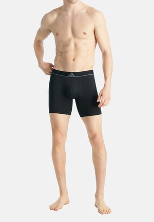 Schwarze Sportshorts aus dehnbarem Stoff, mit einem breiten elastischen Bund in Grauton und einem figurbetonten Design.