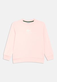 Sweatshirt rosa claro feita de material macio, com gola redonda, mangas compridas, punhos canelados e o logótipo da Lacoste em branco na frente.