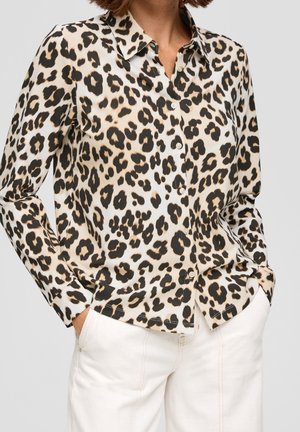 Overhemd met luipaardprint in crème-, zwart- en tan-kleuren, met een kraag en lange mouwen, gecombineerd met een witte broek.