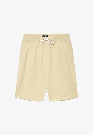 Jasnobeżowe szorty wykonane z miękkiej tkaniny, wyposażone w elastyczną talię ze sznurkiem, dwie boczne kieszenie oraz zagięty brzeg.