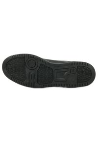 Suola in gomma nera per sneaker con motivi a nido d'ape e un accento circolare, progettata per trazione e durata.