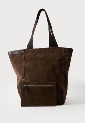 Sac cabas en daim marron foncé avec des poignées noires et une pochette rectangulaire zippée assortie fixée à l'avant.