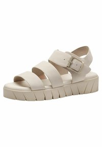 Sandales à plateforme blanches avec trois larges brides et une boucle réglable. La semelle a une texture striée pour une meilleure adhérence.