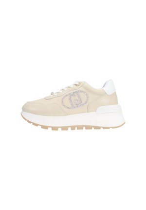 Sneakers con una parte superiore in cuoio beige, suola bianca e dettagli in beige chiaro; presentano un logo decorativo in argento sul lato.