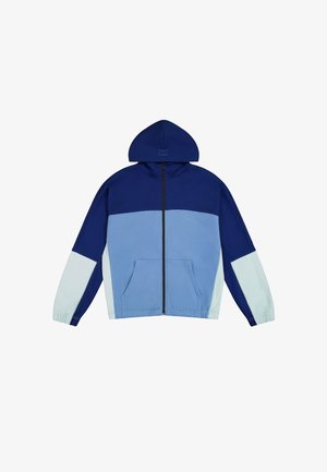 Kapuzensportjacke mit Farbblockdesign in Marineblau und Hellblau. Aus weichem Material gefertigt, mit einem Frontreißverschluss und seitlichen Taschen.