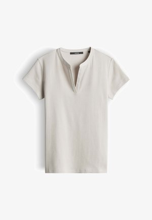 Hellbeiges kurzärmeliges, geripptes Oberteil mit rundem Ausschnitt und minimalen Nahtdetails, flach auf weißem Hintergrund liegend.