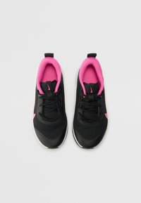 Black athletic shoes with pink accents, textured mesh upper, white sole, and laces. Features a pull tab for easy wear.