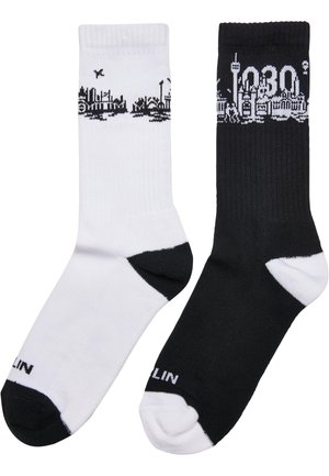 Socken in Schwarz und Weiß mit einem Skylinedesign in kontrastierenden Farben, aus strukturiertem Stoff und mit gerippten Bündchen. Markenlogo an der Sohle.