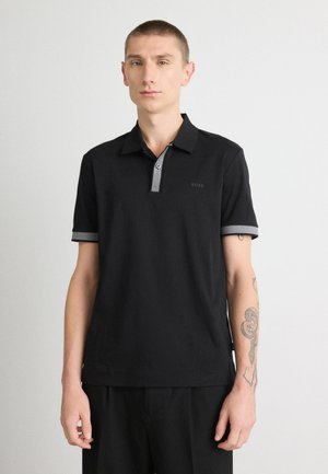 Black polo shirt with a grey collar and sleeve accents. Features a minimalistic design and 'BOSS' logo on the left side. Smooth texture.