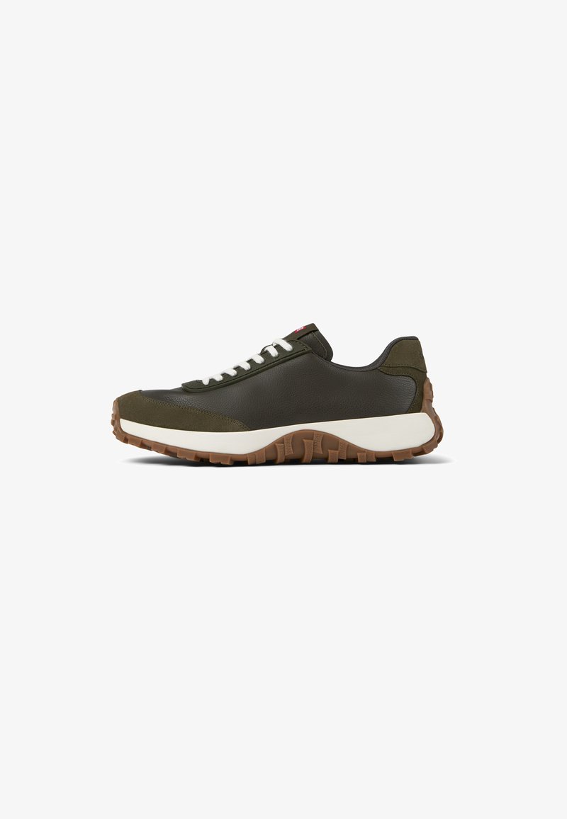 Olive green sneaker with leather upper, white laces, and a textured brown rubber sole. Features a rounded toe and low profile design.