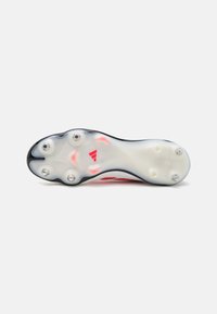 Red soccer cleat with a translucent white sole, featuring six studs and a Copa logo. The design includes a smooth upper surface.