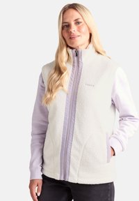 Fleece vest in cream with a lavender interior. Features a high collar, zip closure, side pockets, and contrasting sleeve details.
