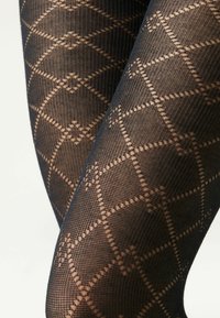 Collants noirs à motif, présentant un design en grille de diamants avec des accents beige contrastants. La texture est transparente avec un tissage fin.