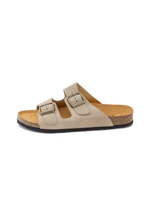 Sandalia beige de ante con dos correas, hebillas de metal ajustables, plantilla de corcho y suela de caucho negra, vista lateral.
